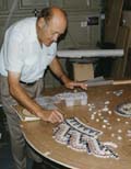 [My father testing the marble pieces for size on his design]